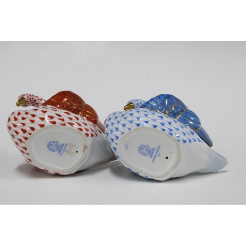 147 - Two Herend handpainted fishnet porcelain swans, one in blue and the other red, with printed factory ... 