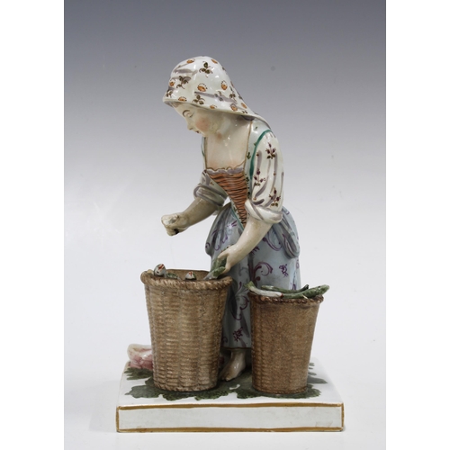 153 - Continental lead glazed figure of a fisherwoman with baskets of fish, 19cm