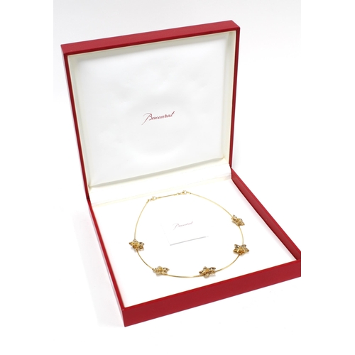 23 - BACCARAT Les Bijoux 18ct gold necklace with five flowerheads, stamped 750, with original box