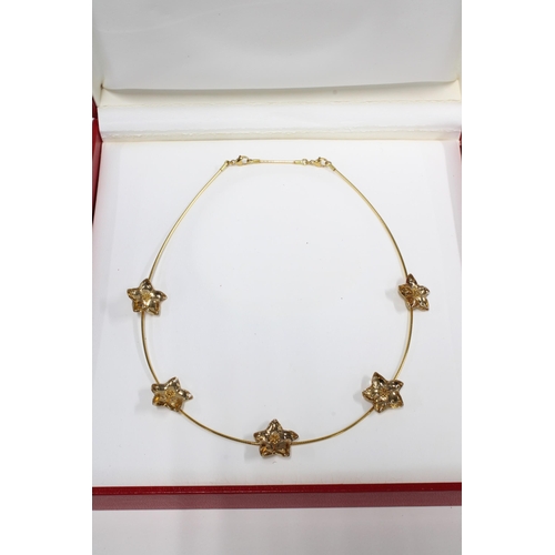 23 - BACCARAT Les Bijoux 18ct gold necklace with five flowerheads, stamped 750, with original box