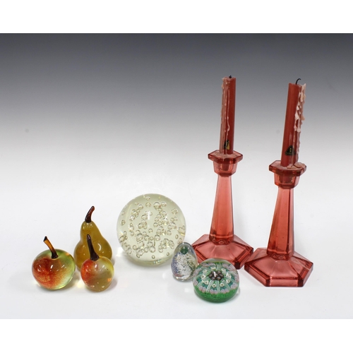 403 - Pair of pink moulded glass candlesticks, 19cm, together with three glass pieces of fruit, a large bu... 