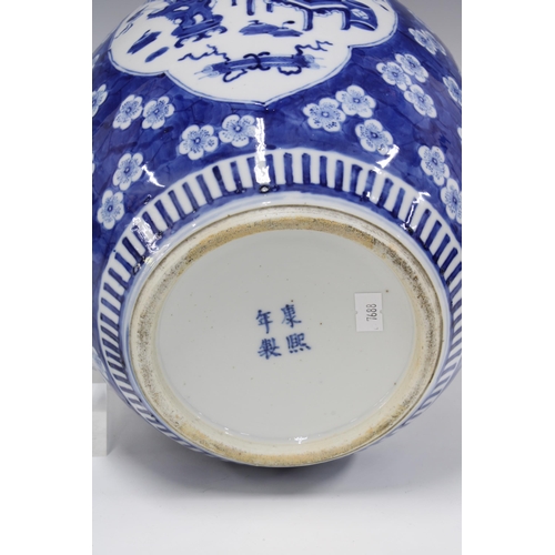 421 - Large Chinese blue and white jar and cover, with prunus ground and panels of precious objects, four ... 