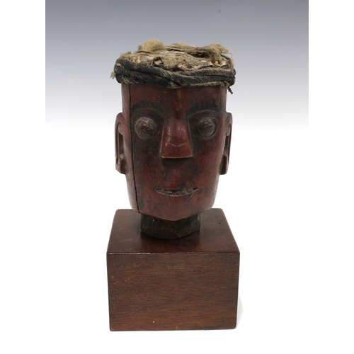 426 - Dayak wooden head on a square plinth base, 27cm