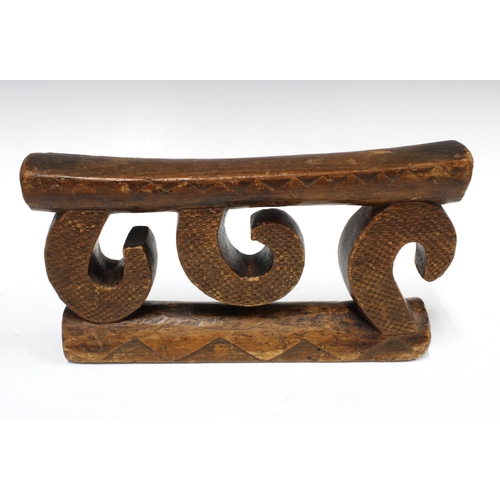 427 - Nguni (South Africa) neckrest, supported on three carved wooden scrolls, 17 x 31cm