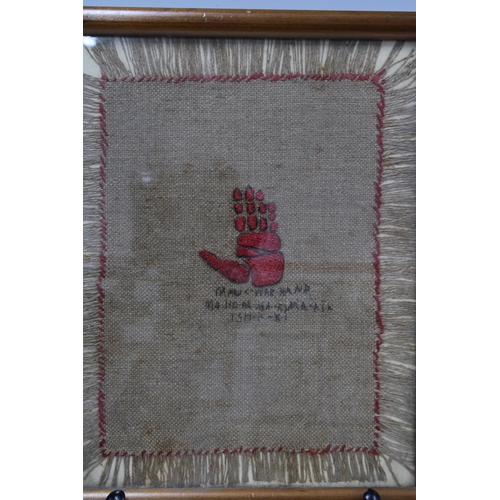 428 - North American weaving, with red stitched war hand, the textile panel with fringed border, framed un... 