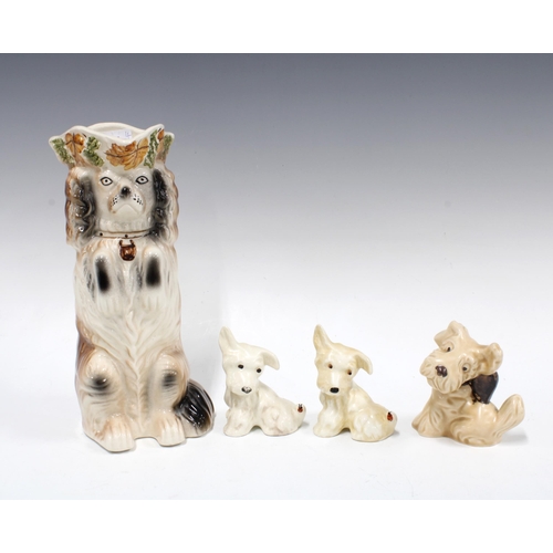 465 - Two Beswick dogs, model 805, Sylvac dog model 1119 and a Staffordshire dog jug, 26cm (4)