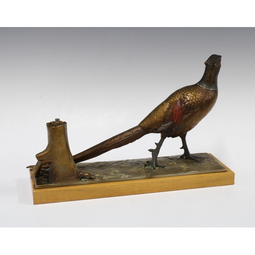 470 - Cold painted spelter pheasant on a wooden base, 32cm long