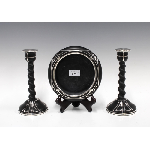 471 - Silver overlaid gantirue of black pottery to include a bowl and pair of candlesticks, (3) 21cm high