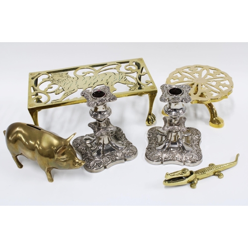 496 - Two brass trivets, brass pig money bank and brass nutcrackers together with a pair of silver plated ... 