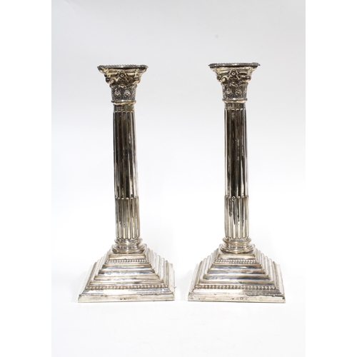 63 - A pair of George V silver Corinthian column candlesticks, Birmingham 1938 (weighted) 30cm (2)