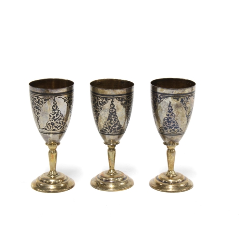 83 - A set of three Russian, Soviet Period silver and niello miniature goblets, stamped 875 with a hammer... 