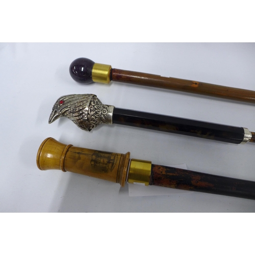 534 - Cane with a white metal bird and faux tortoiseshell head, 93cm, together with an amethyst cane and a... 