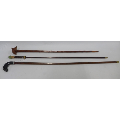 535 - Walking stick with a bird head handle, 97cm, together with a tortoise head stick and cane with paint... 