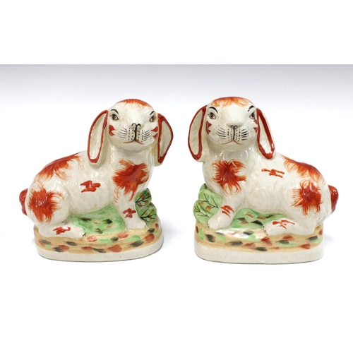 104 - Pair of Staffordshire pottery rabbits, 21cm (2)