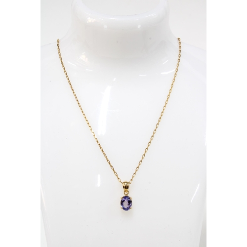 12 - Tanzanite pendant necklace set in 18ct gold, on a 14ct gold trace link chain