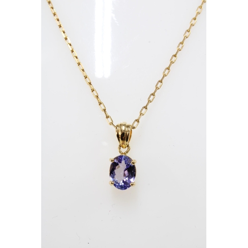 12 - Tanzanite pendant necklace set in 18ct gold, on a 14ct gold trace link chain