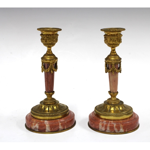 135 - Pair of Neoclassical pink marble / hardstone and brass candlesticks, 16cm (2)