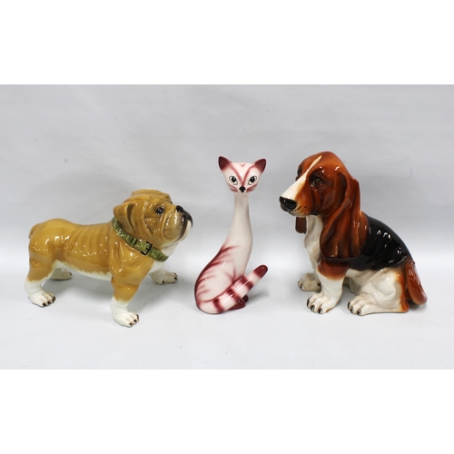 145 - A large Sylvac cat, model number 3457 and two pottery dogs, larger 33cm, (3)