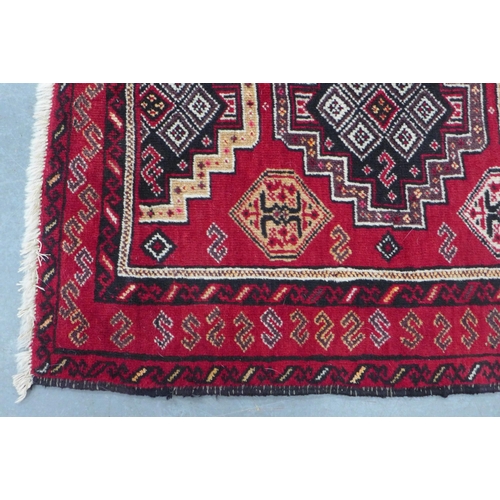 201 - Persian Kazak style rug with red field with multiple borers, 197 x 109