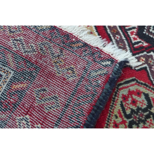 201 - Persian Kazak style rug with red field with multiple borers, 197 x 109