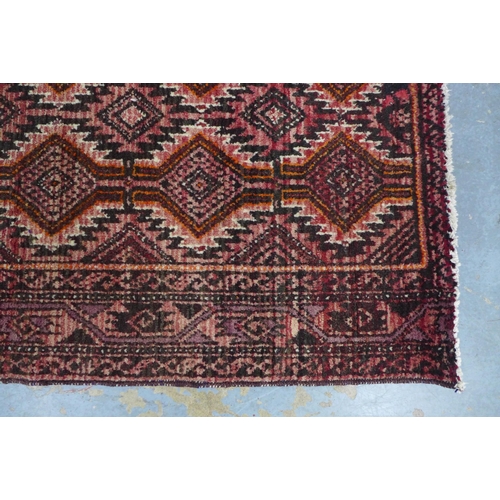 217 - An Afghan Belouch rug with red field 190 x 112cm