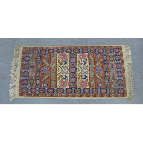 218 - An Eastern wool rug with cream, red and blue  striped pattern, 141 x 69cm