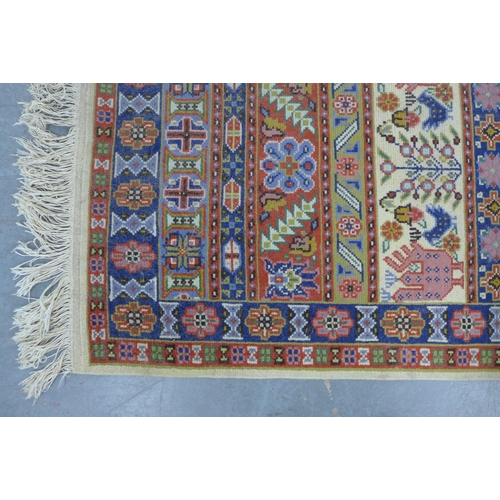 218 - An Eastern wool rug with cream, red and blue  striped pattern, 141 x 69cm