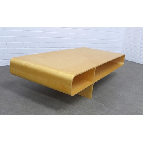 219 - An Isokon Loop coffee table designed by Barber Osgerby, in birch ply, 134 x 30 x 60cm