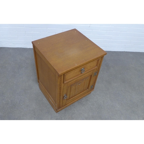 228 - Oak bedside cabinet with linen fold pattern, 52 x 70 x 50cm.