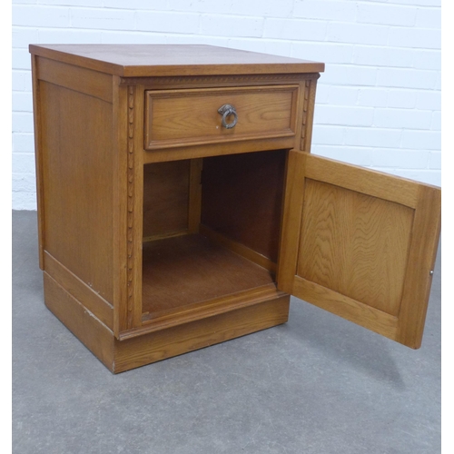 228 - Oak bedside cabinet with linen fold pattern, 52 x 70 x 50cm.