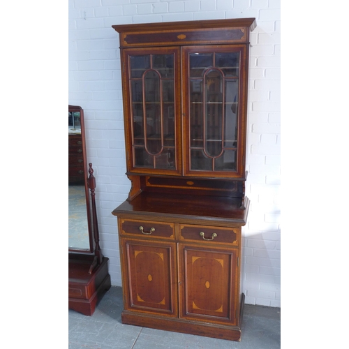 242 - Late 19th century mahogany inlaid bookcase cabinet, with projecting cornice over a pair of glazed do... 