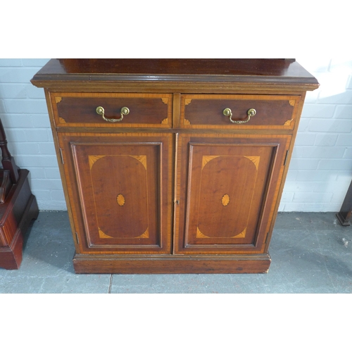 242 - Late 19th century mahogany inlaid bookcase cabinet, with projecting cornice over a pair of glazed do... 