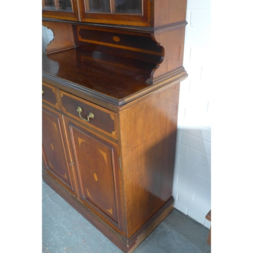 242 - Late 19th century mahogany inlaid bookcase cabinet, with projecting cornice over a pair of glazed do... 