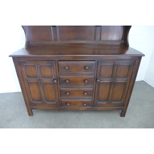 281 - A vintage dark elm Ercol style dresser, 146 x 170 x 50cm.