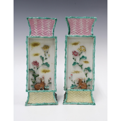 301 - Pair of chinoiserie vases, relief decorated panels with flowers and rabbits and a basket weave patte... 