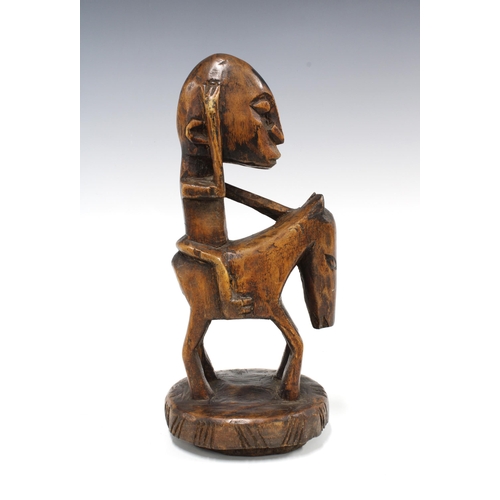 333 - IVORY COAST carved wood figure of a rider on horseback, 28cm