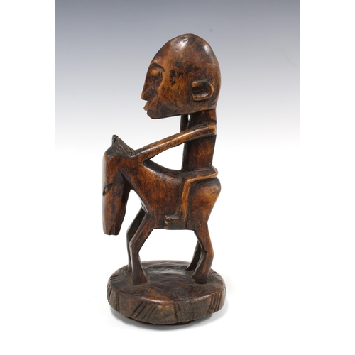 333 - IVORY COAST carved wood figure of a rider on horseback, 28cm