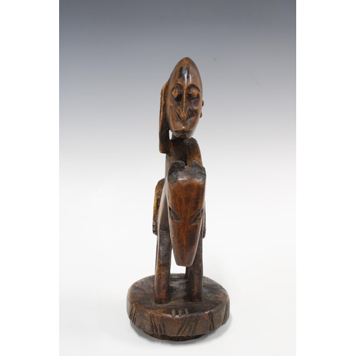 333 - IVORY COAST carved wood figure of a rider on horseback, 28cm