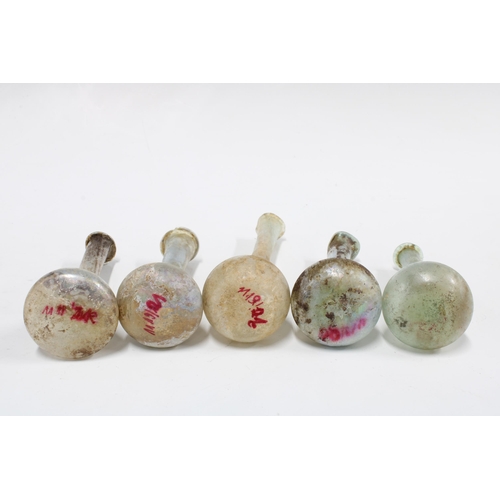 343 - A collection of five Roman glass perfume bottles, CA 3rd century AD,  tallest 17cm high (5)