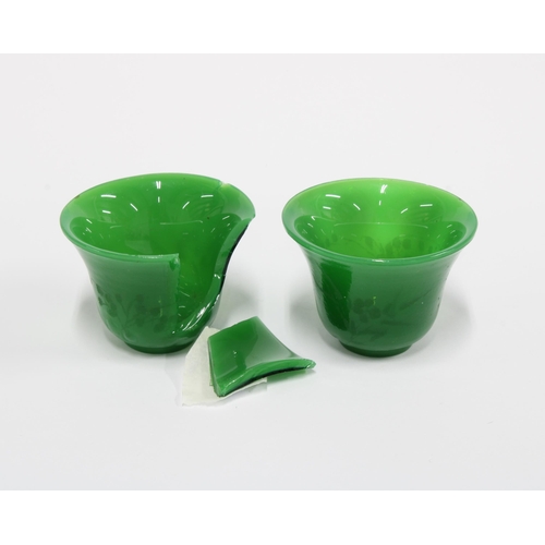 355 - Two Chinese green Peking glass wine cups with engraved floral pattern (one a/f) 5.5cm diameter