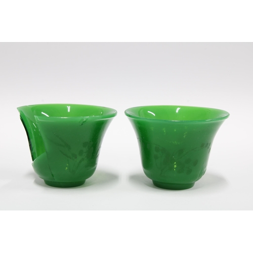 355 - Two Chinese green Peking glass wine cups with engraved floral pattern (one a/f) 5.5cm diameter