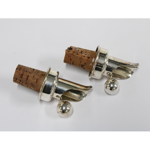 36 - A pair of silver plated bottle corks (2)