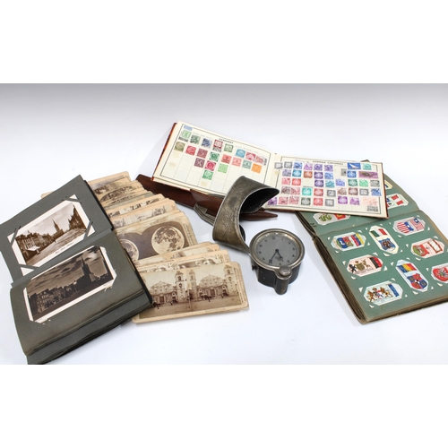 375 - Stereoscope viewer and a selection of cards, early 20th century postcard album with a quantity of ca... 