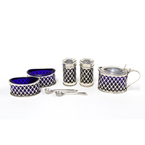 42 - George V silver five piece condiment set with pierced design and blue glass liners, Birmingham 1915 ... 