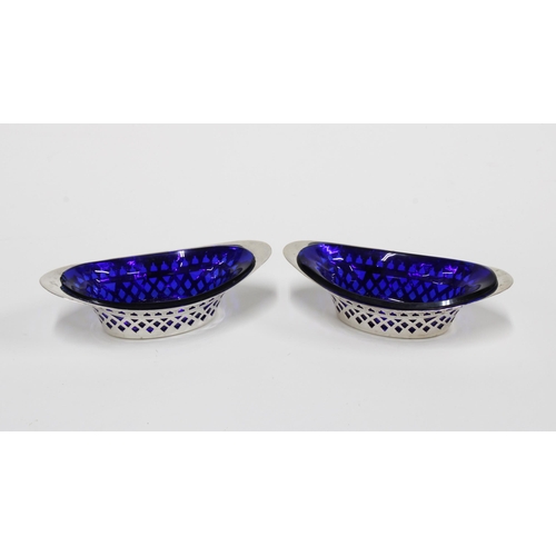 45 - A pair of late Victorian silver salts, pierced design with blue glass liners, Sheffield 1900, 11.5cm... 