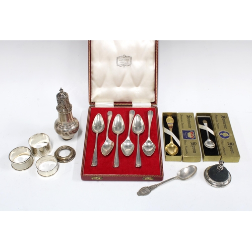 93 - Cased set of six silver grapefruit spoons, two silver souvenir spoons, silver pin cushion, napkin ri... 