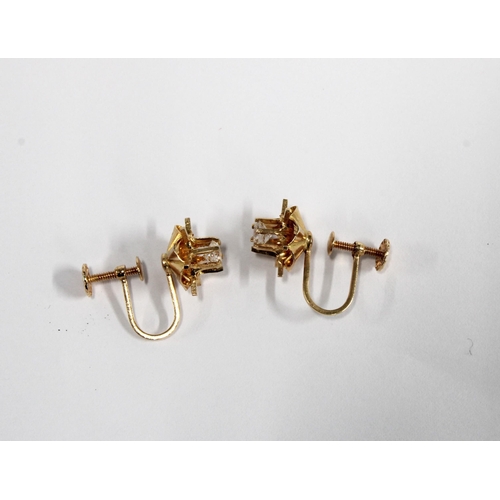 94 - A pair of flowerhead earrings, set in unmarked yellow metal, one stone tests as a diamond, approx 0.... 