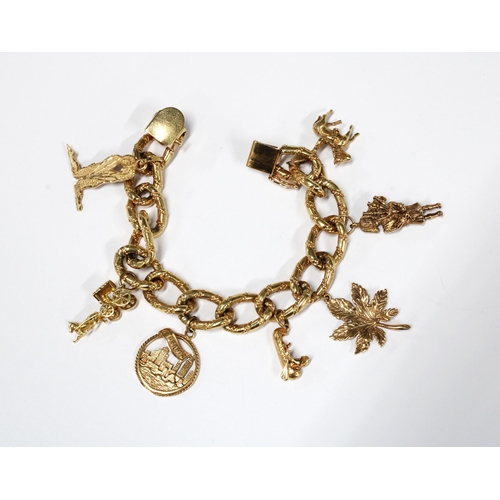 95 - 14K yellow gold  bracelet with eight gold charms to include an 18k kneeling lovers, 14k canoe, 14k c... 