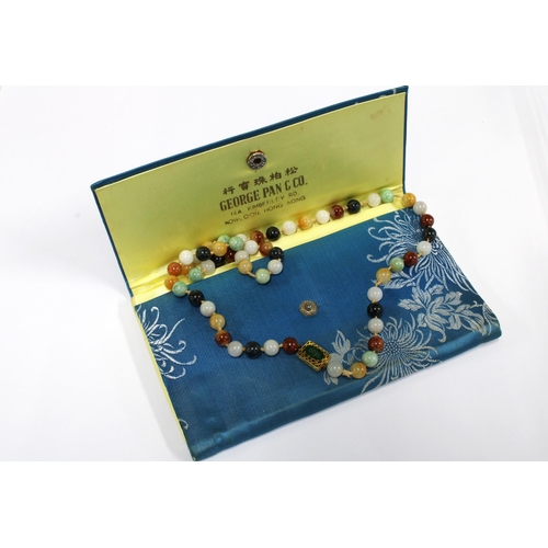 96 - A strand of vintage jade and coloured hardstone beads, the gold clasp with a green jade plaque and s... 