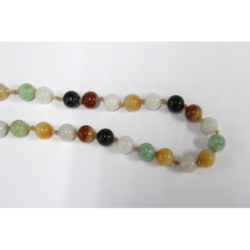 96 - A strand of vintage jade and coloured hardstone beads, the gold clasp with a green jade plaque and s... 